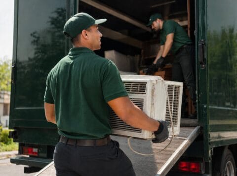 Loading an AC Unit Into a Truck For Disposal
